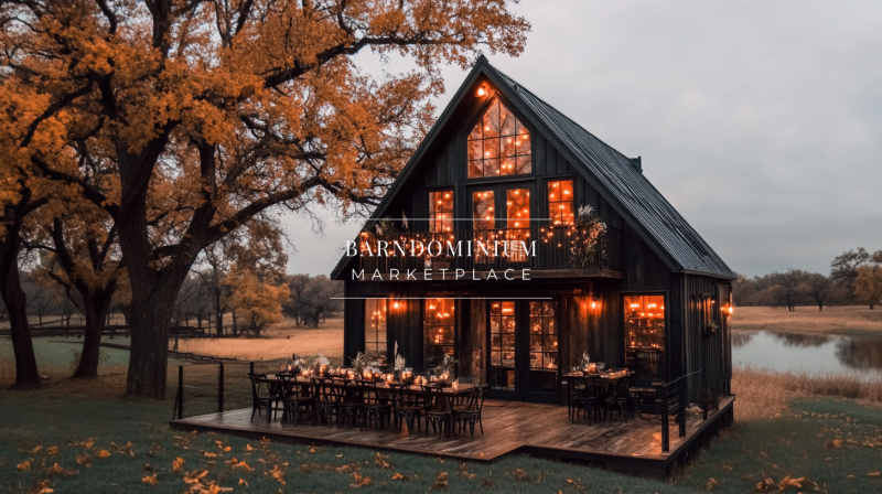 A charming A-frame barndominium with floor-to-ceiling windows, glowing warmly against an autumn backdrop, nestled by a peaceful pond.