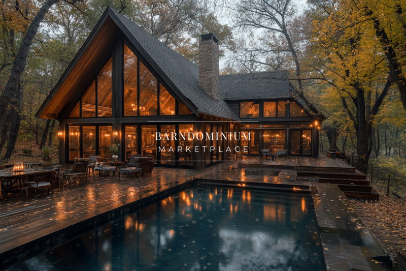 A beautiful A-frame barndominium nestled in the woods, featuring warm glowing lights, a sleek pool, and a rustic-modern design perfect for a serene getaway.