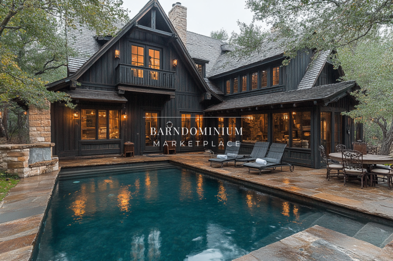 A charming black barndominium with a modern rustic aesthetic, featuring a serene pool, cozy outdoor seating, and warm interior lighting.