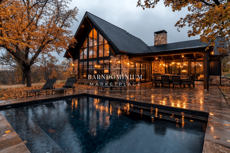 A cozy barndominium exterior in autumn, featuring warm glowing lights, a sleek pool, and rustic stone accents for the perfect seasonal retreat.