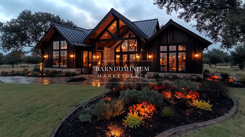 Stunning modern barndominium with warm lighting and vibrant landscaping.