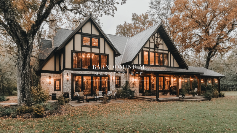 Elegant Tudor-style barndominium with warm lighting, large windows, and a cozy autumn landscape.