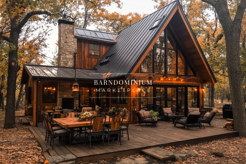 Rustic barndominium exterior with a black metal roof, stone chimney, and a spacious wooden deck, surrounded by autumn foliage.