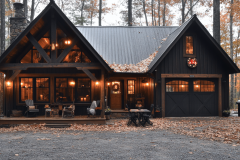 A cozy black barndominium nestled in the autumn woods, featuring warm lighting, rustic decor, and a charming garage, perfect for a peaceful retreat.