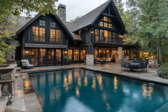 A luxurious black barndominium with expansive glass windows, warm interior lighting, and a beautiful poolside patio, offering a perfect blend of rustic and modern charm.