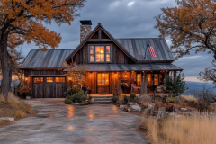 Charming barndominium exterior with rustic wood siding, a warm-lit porch, and a scenic countryside setting, perfect for modern country living.