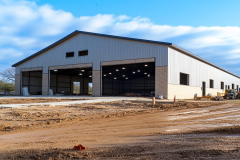 A large steel barndominium with multiple garage bays, ideal for workshops, storage, or commercial use.