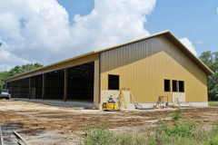 Large metal barndominium under construction with open sides and a spacious interior layout.