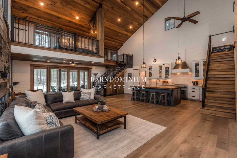 Modern farmhouse barndominium with an open-concept living space, vaulted ceilings, and a stylish loft.