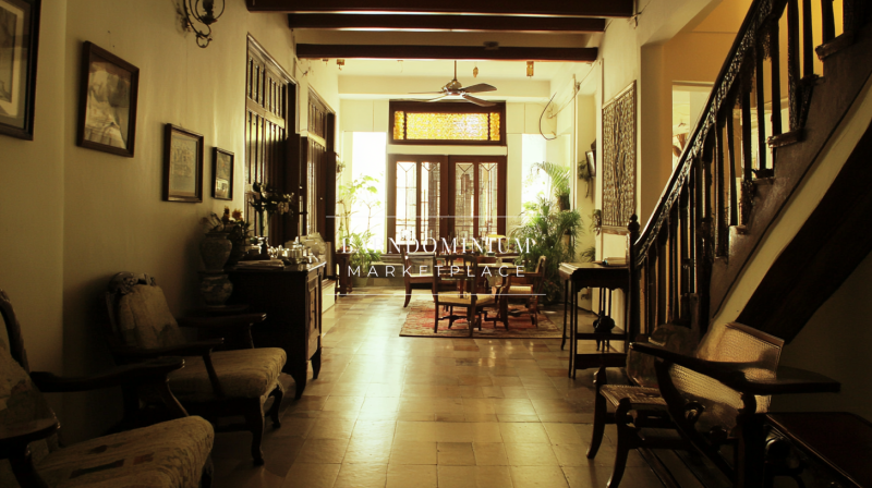 Elegant heritage-style barndominium interior with vintage wooden furniture and warm ambient lighting.