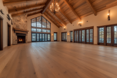 Spacious barndominium great room with vaulted ceilings, exposed wood beams, and a grand fireplace.