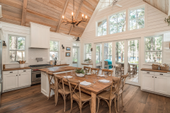Bright and airy farmhouse kitchen with natural wood tones and large windows.