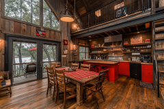 Rustic barndominium kitchen with a bold red accent, wood-paneled walls, and an inviting open loft space.