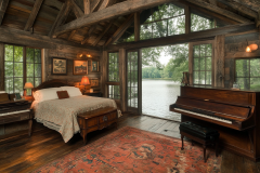 Cozy rustic bedroom with lakefront views and vintage decor.