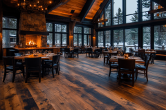Cozy rustic restaurant with a grand stone fireplace and panoramic winter views.