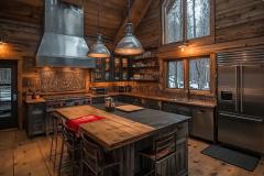 Rustic barndominium kitchen with exposed wood beams and industrial accents.