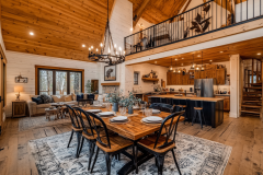 Warm and inviting barndominium interior featuring an open-concept kitchen, rustic wood finishes, and a lofted second floor.