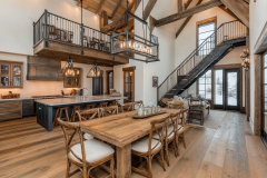 Elegant barndominium interior with exposed beams, a lofted second floor, and a spacious open-concept kitchen and dining area.