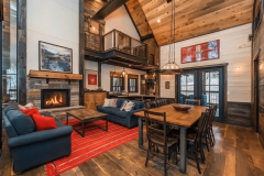 Charming barndominium interior with a cozy fireplace, high ceilings, and a perfect blend of rustic and modern design elements.