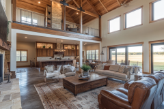 Spacious barndominium living area with high ceilings, large windows, and an open-concept kitchen.