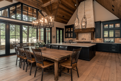 Elegant barndominium dining area with high vaulted ceilings, rustic wooden finishes, and a spacious open-concept kitchen.