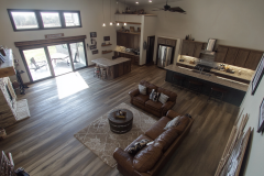 Spacious barndominium interior with an open floor plan, high ceilings, and a cozy rustic design.