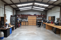 Spacious barndominium workshop with high ceilings, durable concrete flooring, and organized workstations for ultimate functionality.