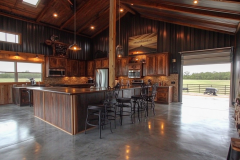 This spacious barndominium seamlessly blends rustic wood finishes, metal siding, and open-concept living—creating a warm and functional farmhouse design.