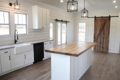 Minimalist Farmhouse Barndominium Kitchen with Shiplap Walls and Barn Door