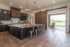 Elegant Barndominium Kitchen with Sliding Barn Doors and Outdoor Living Space