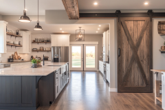 Bright and Airy Barndominium Kitchen with Rustic Barn Door and Farmhouse Charm
