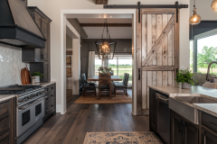 Elegant Barndominium Kitchen with Rustic Barn Door and Farmhouse Touches