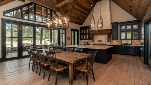 This beautifully designed barndominium features a rustic yet modern farmhouse kitchen, vaulted wood ceilings, elegant lighting, and an open dining space perfect for entertaining.